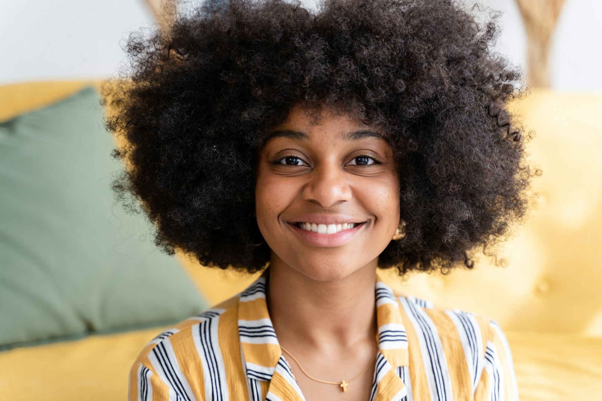 Cheerful black woman with curly hair