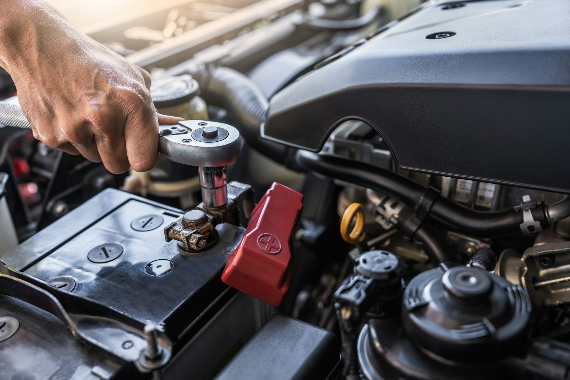 Hand technician worker checking car battery for power electric prepare start with wrench tool